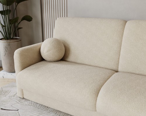 Detal miękkiego boczku sofy LUMENA w luksusowej tkaninie bouclé QUELL.