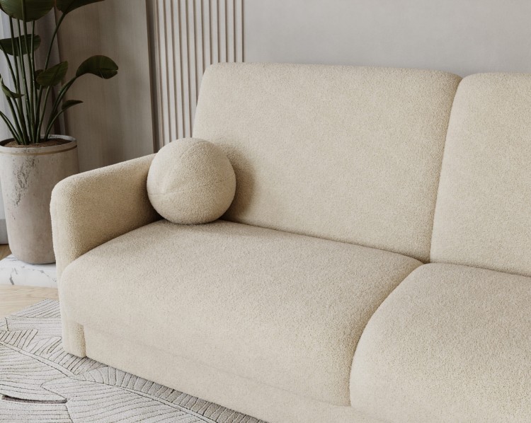 Detal miękkiego boczku sofy LUMENA w luksusowej tkaninie bouclé QUELL.